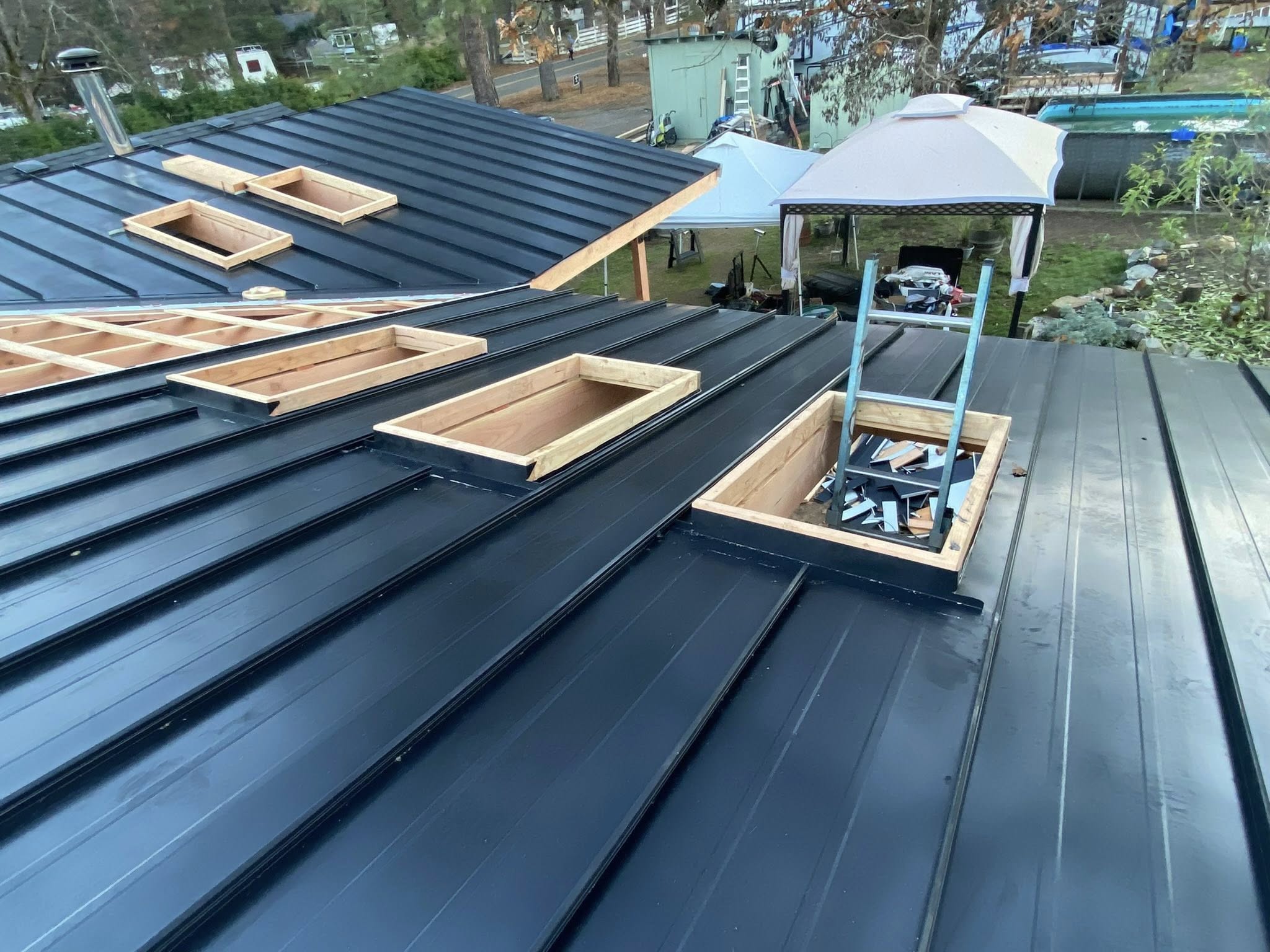 Standing seam metal roof installation with skylight framing completed by Mike McCloud Construction in Southern Oregon