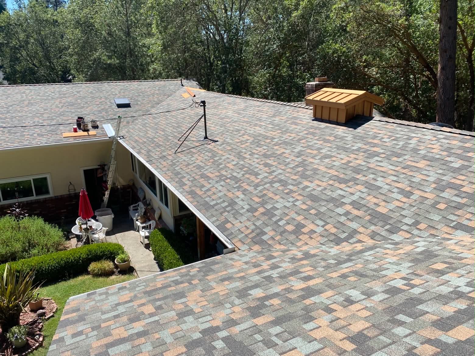 Mike McCloud Construction asphalt shingle roof replacement on a Southern Oregon home with architectural shingles and rooftop skylight.
